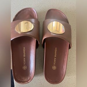Brown and gold Tory Burch platform slides